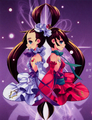 Ayase (left) and Luca (right) in color on the cover of volume 2. Note that the shape of each girl's soul gem appears on the costume of her partner